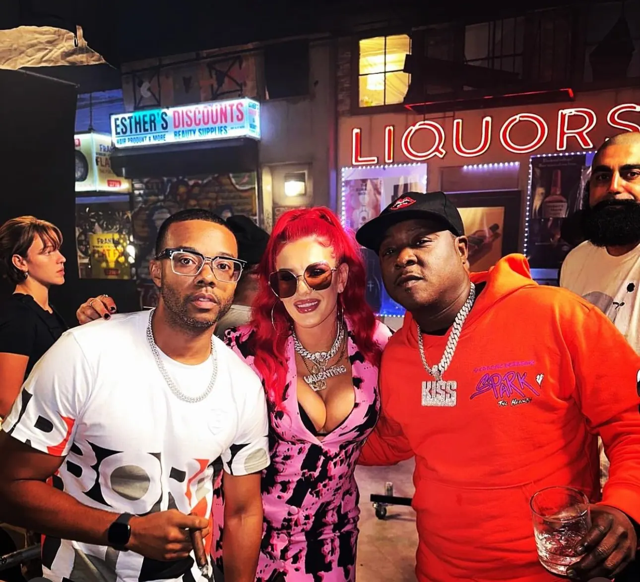 Guests posing in front of the neon Liquors sign