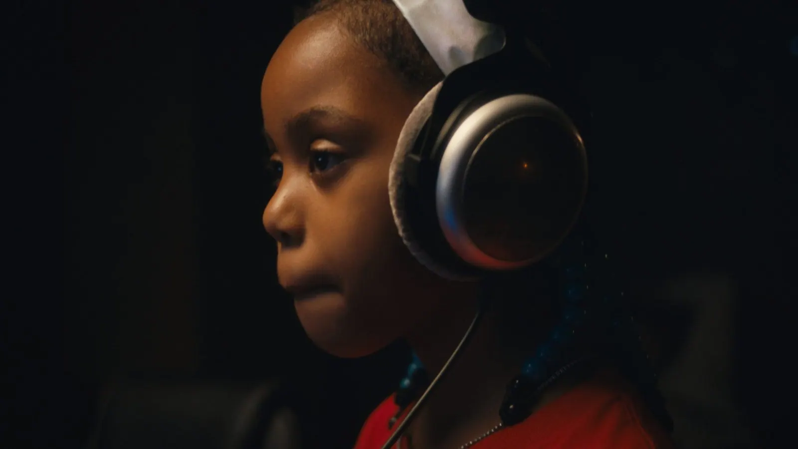 A child wearing studio headphones during a session