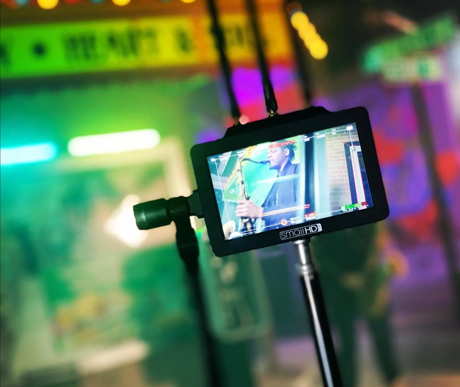 On-set camera monitor in a neon-lit scene