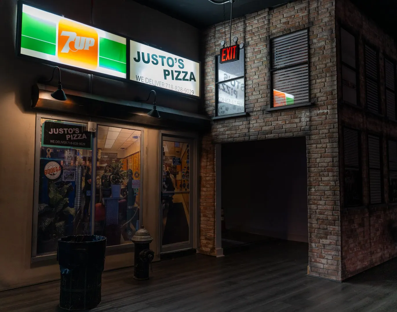 Pizza shop storefront with a brick facade on the set