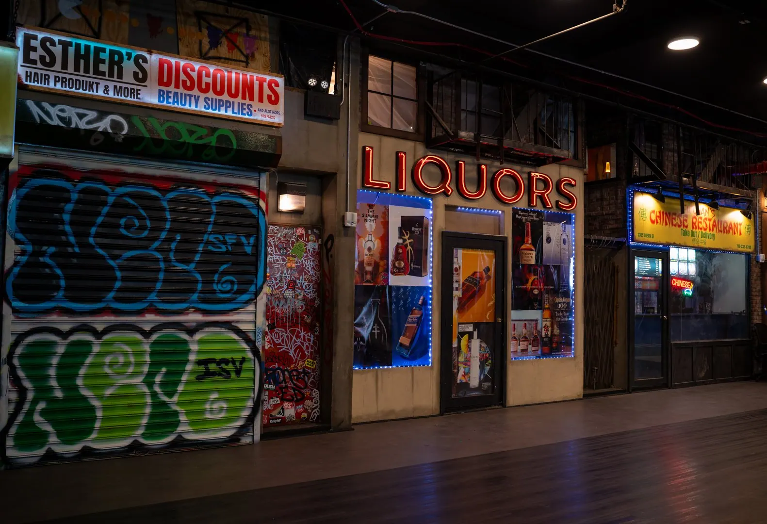 The indoor street set with Esther's Discounts, graffiti roll-down gates and a Liquors store