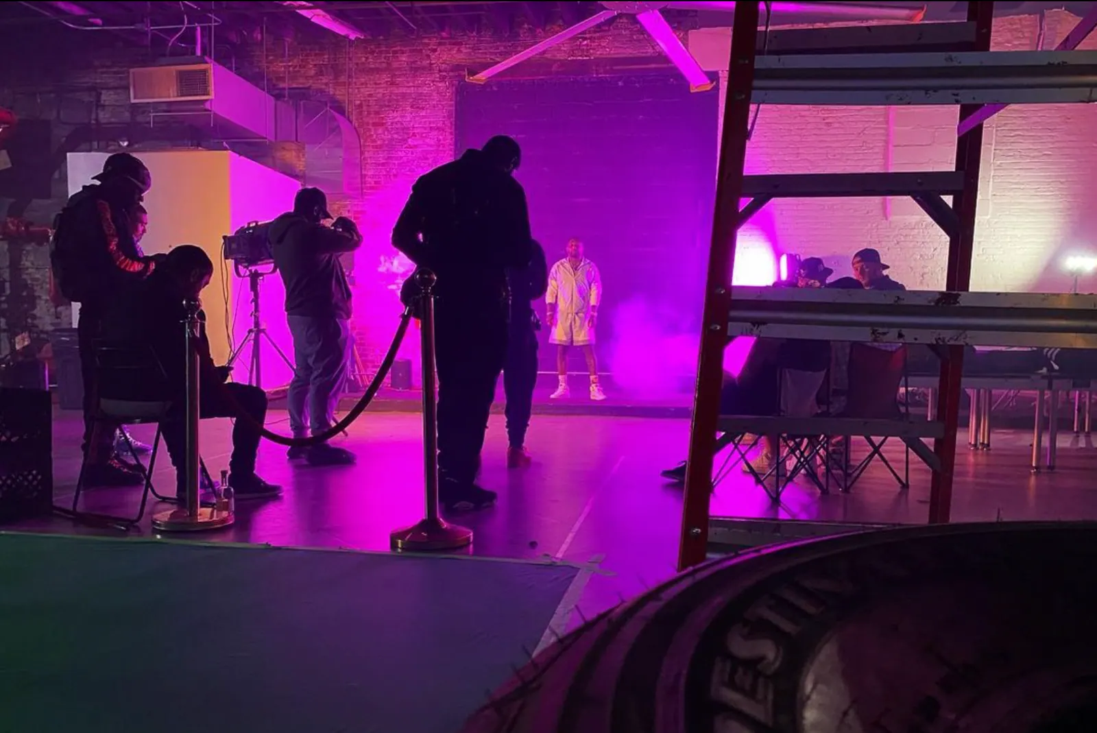 Film crew shooting on the soundstage under purple light
