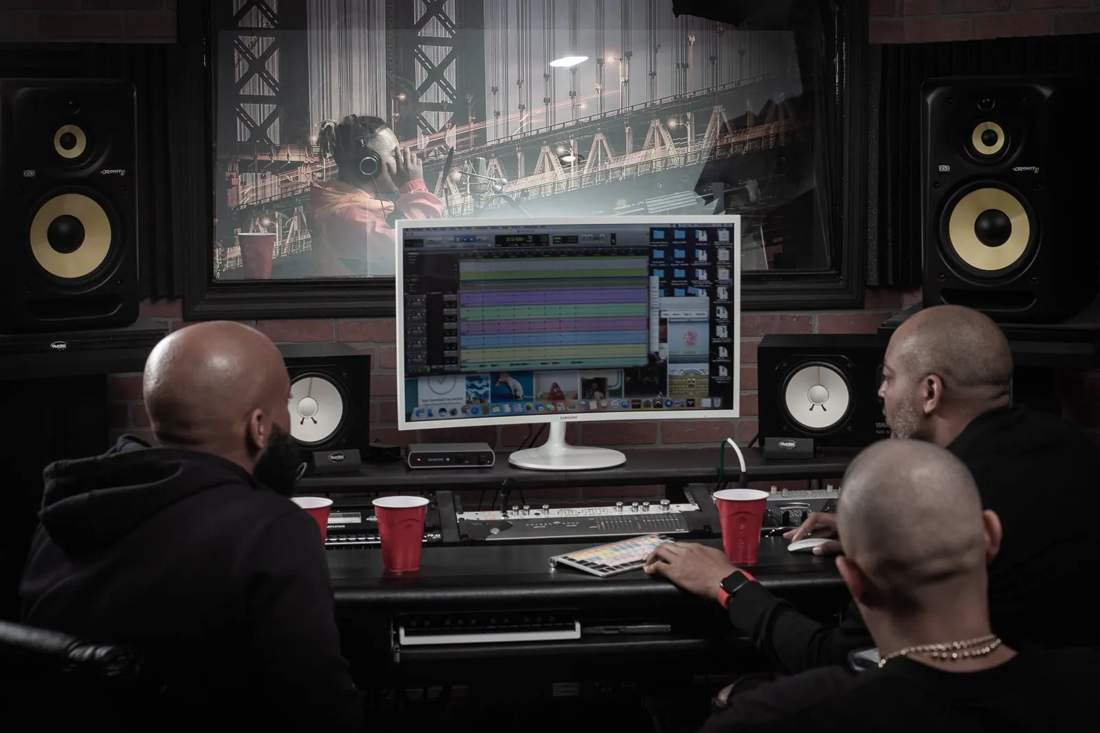 Recording studio control room with an engineer at the desk